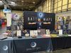 Moonlight Maps creator Ollie Chanter standing with TTRPG battle maps at the UKGE convention